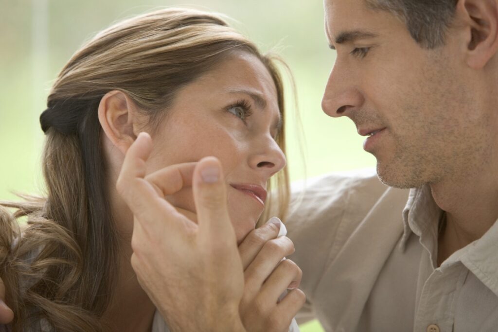 Un homme reconfortant la femme en touchant son visage