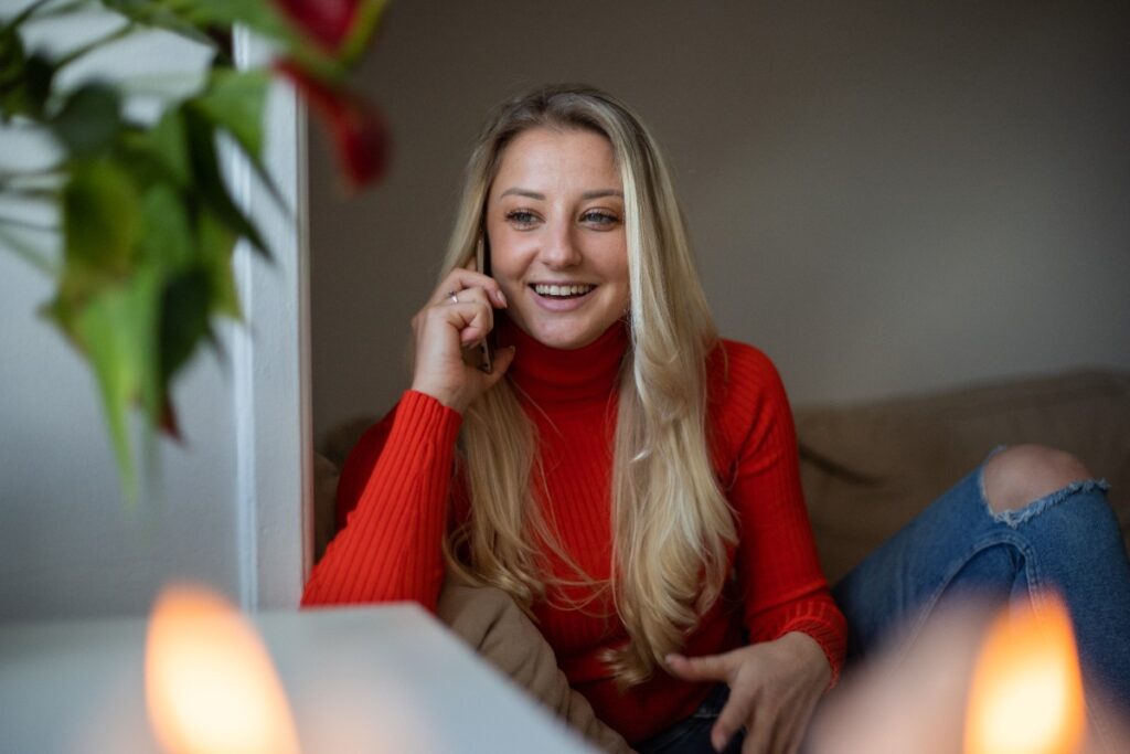 Une femme souriante en prenant un appel